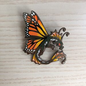 black nickel hard enamel pin with orange gradient pearl effect on the wings